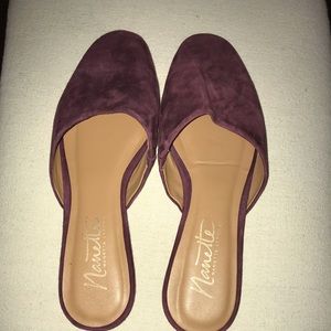Purple suede mules.